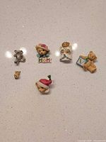 All six teddy bear pins arranged on surface