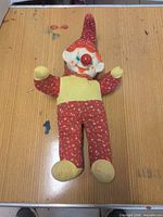 Full view of clown rag doll on tabletop
