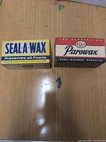 Front view of both boxed paraffin wax products