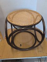 Front view of round cane top bentwood side table