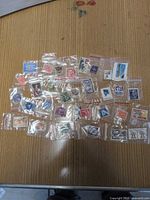Overview of 30 bagged stamps spread on table