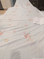 Full view of tablecloth spread out with one folded napkin visible