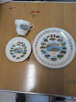 Full view of teacup, saucer and plate on tabletop