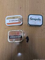 Group shot of all three tins showing size and branding