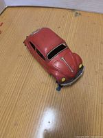 Top view of red tin Volkswagen-style car