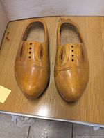 Top view of both wooden clogs showing painted motifs