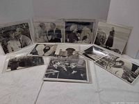 All fourteen 8x10 publicity photos displayed in sleeves on flat surface