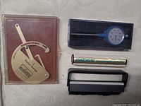 Lot overview: stylus gauge, dial gauge, Koss roller, brush