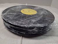 Stack of vinyl LPs wrapped in plastic