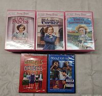 Front covers of three Shirley Temple DVDs plus sealed Damsels in Distress and About Last Night