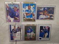 Front view of all six sleeved baseball cards