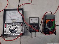 All three multimeters side by side showing size and type