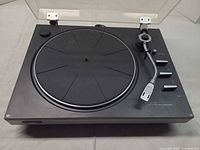 Full view of JVC JL-A20 turntable with platter, tonearm, controls and raised dust cover