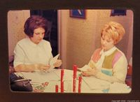 Two women at table slide in mount