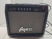 Front view of Aspire GA-30 amplifier showing controls, grille, logo, attached power cord