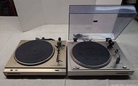 Both Marantz turntables side by side showing overall condition and included dust covers