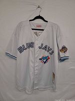 Front view of jersey showing team lettering, logo patch, jock tag