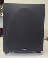 Front view of Definitive Technology ProSub 1000 powered subwoofer showing black cloth grille and brand badge