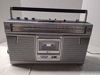 Front view of Sharp GF-6161Z showing speakers, cassette deck, tuner scale and controls