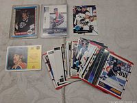 Group shot of all cards including two in toploaders and fanned stack