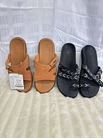 Both pairs of sandals side by side on surface