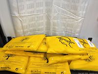 Stack of eight yellow retail pouches for socks