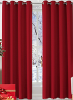 Stock image showing red blackout curtains hung on window