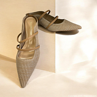 Side angle of heeled mule showing ribbed knit upper, double straps, pointed toe