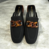 Top view of both black Newbella mules showing pointed toe, mesh upper, tortoise chain, insole branding