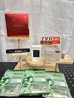 Group shot of all boxed and packaged cosmetics on wooden stand