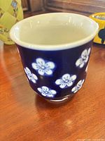 Small cobalt blue ceramic item with white flowers