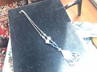 Full view of necklace on dark surface