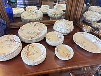 Full set of Chinese Tree dinnerware displayed on sideboard