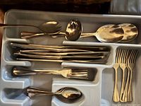 Tray showing assorted knives, forks and spoons