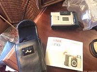 Camera, case, manual on table