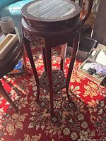 Full view of one stand showing height, legs, stretcher shelf