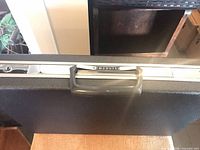 Close-up of Samsonite handle and textured shell