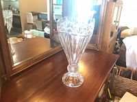 Full view of crystal floor vase on wooden surface