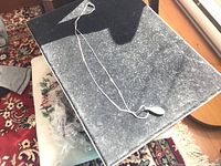 Full view of necklace laid out showing chain and pendant