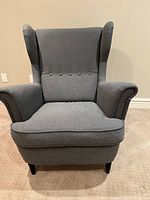 Front view of grey IKEA wingback armchair