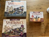 Three sealed Spintronics boxes: Act One, Act Two, Power Pack