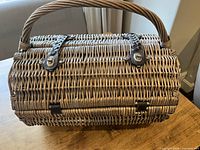 Closed wicker picnic basket showing exterior and handle