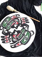 Top view of drum showing painted raven motif and beater