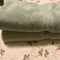 Two folded aqua bath sheets stacked