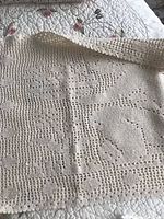 Rectangular crocheted runner laid flat showing lace pattern
