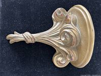 Front view of gold painted wooden sconce with acanthus scrolls