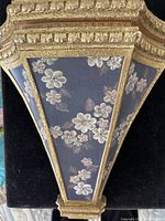Front view showing gold finish and floral panels