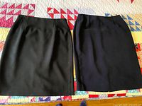 Overall view of both skirts side by side on quilt backdrop