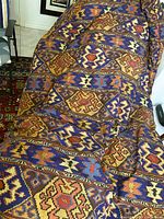 Full view of kilim pattern comforter draped on surface