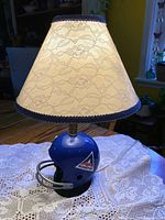 Full view of lamp with shade on helmet base